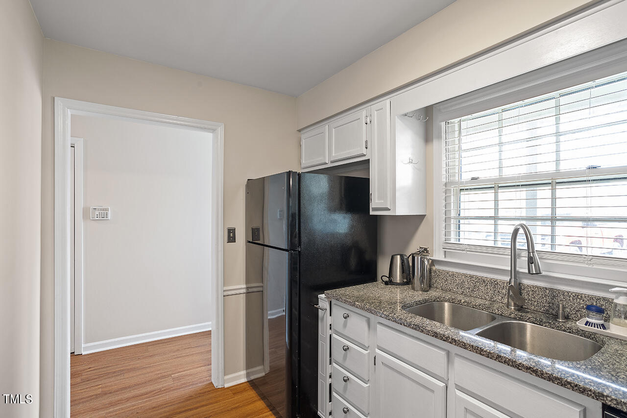 107 Long Shadow Place Durham, NC 27713 - Photo 10 of 31 a kitchen with a refrigerator sink and cabinets