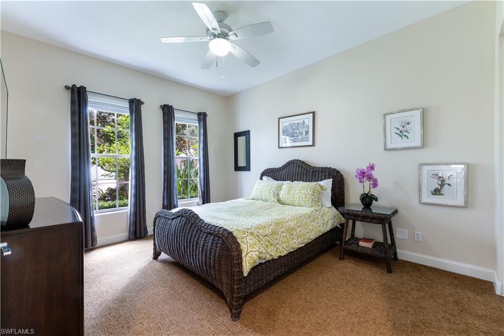 136 Florence Drive Jupiter, FL 33458 - Photo 10 of 23 a bedroom with a large bed couch and a window