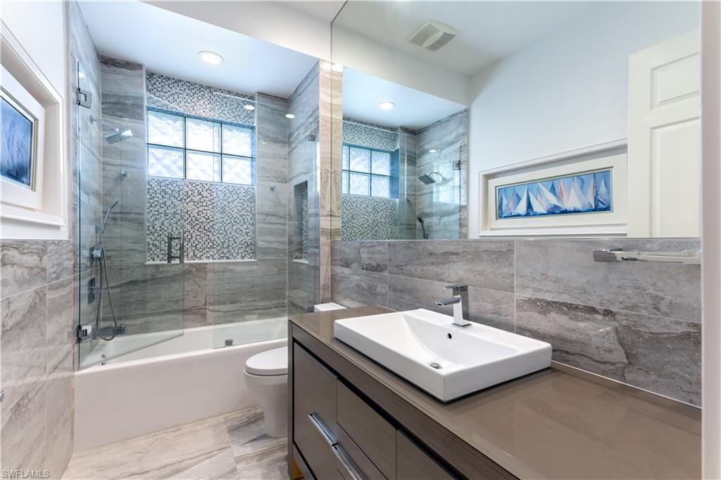 136 Florence Drive Jupiter, FL 33458 - Photo 11 of 23 a bathroom with a sink a toilet and bathtub