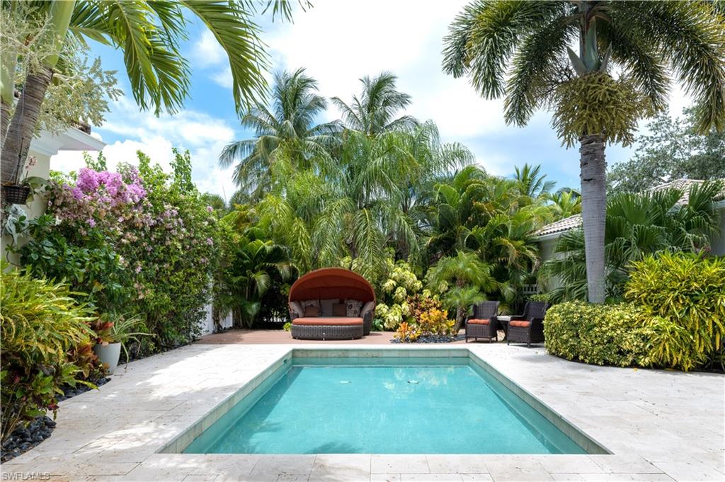 136 Florence Drive Jupiter, FL 33458 - Photo 2 of 23 a view of a swimming pool with an outdoor seating