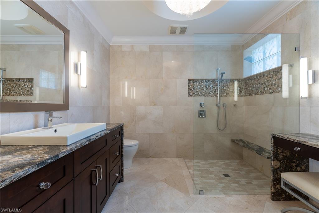136 Florence Drive Jupiter, FL 33458 - Photo 9 of 23 a bathroom with a granite countertop sink a toilet and shower