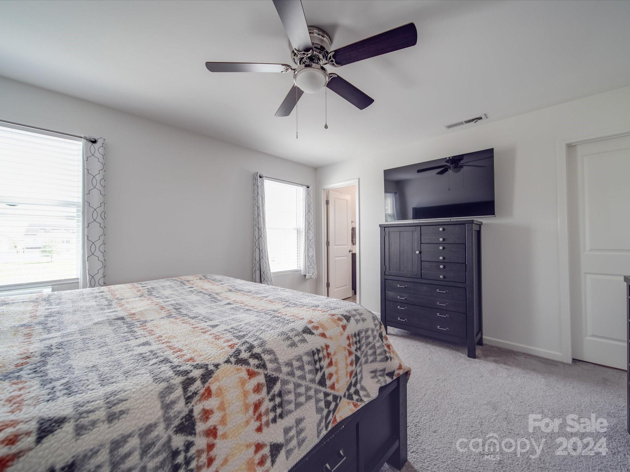 3824 Tersk Drive Midland, NC 28107 - Photo 16 of 39 a bedroom with a bed and a flat screen tv