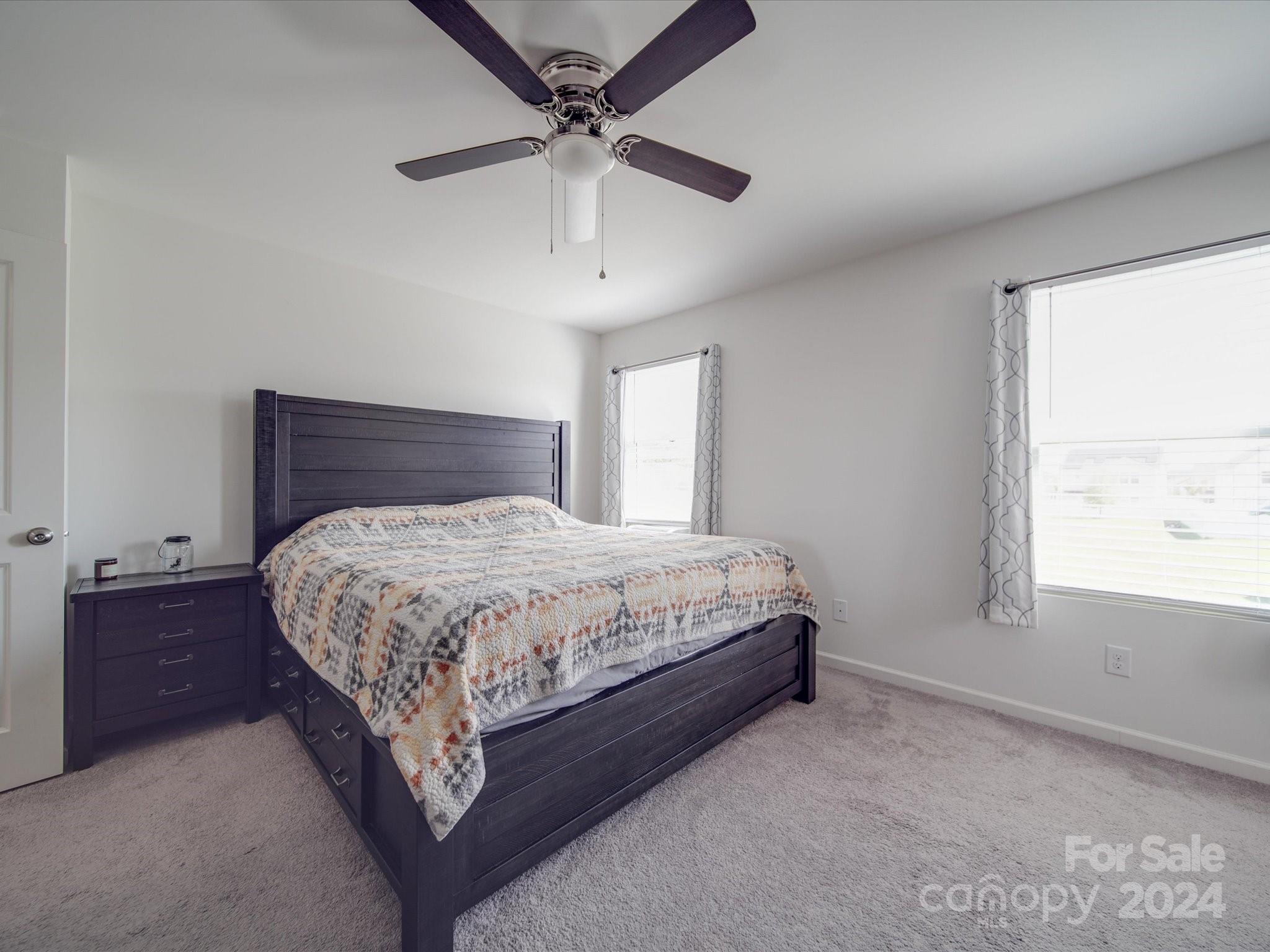3824 Tersk Drive Midland, NC 28107 - Photo 17 of 39 a spacious bedroom with a bed and a chandelier