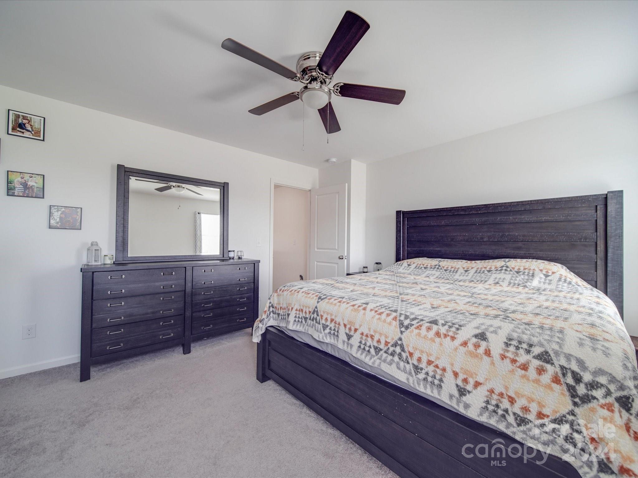 3824 Tersk Drive Midland, NC 28107 - Photo 18 of 39 a bed room with a bed and a chandelier