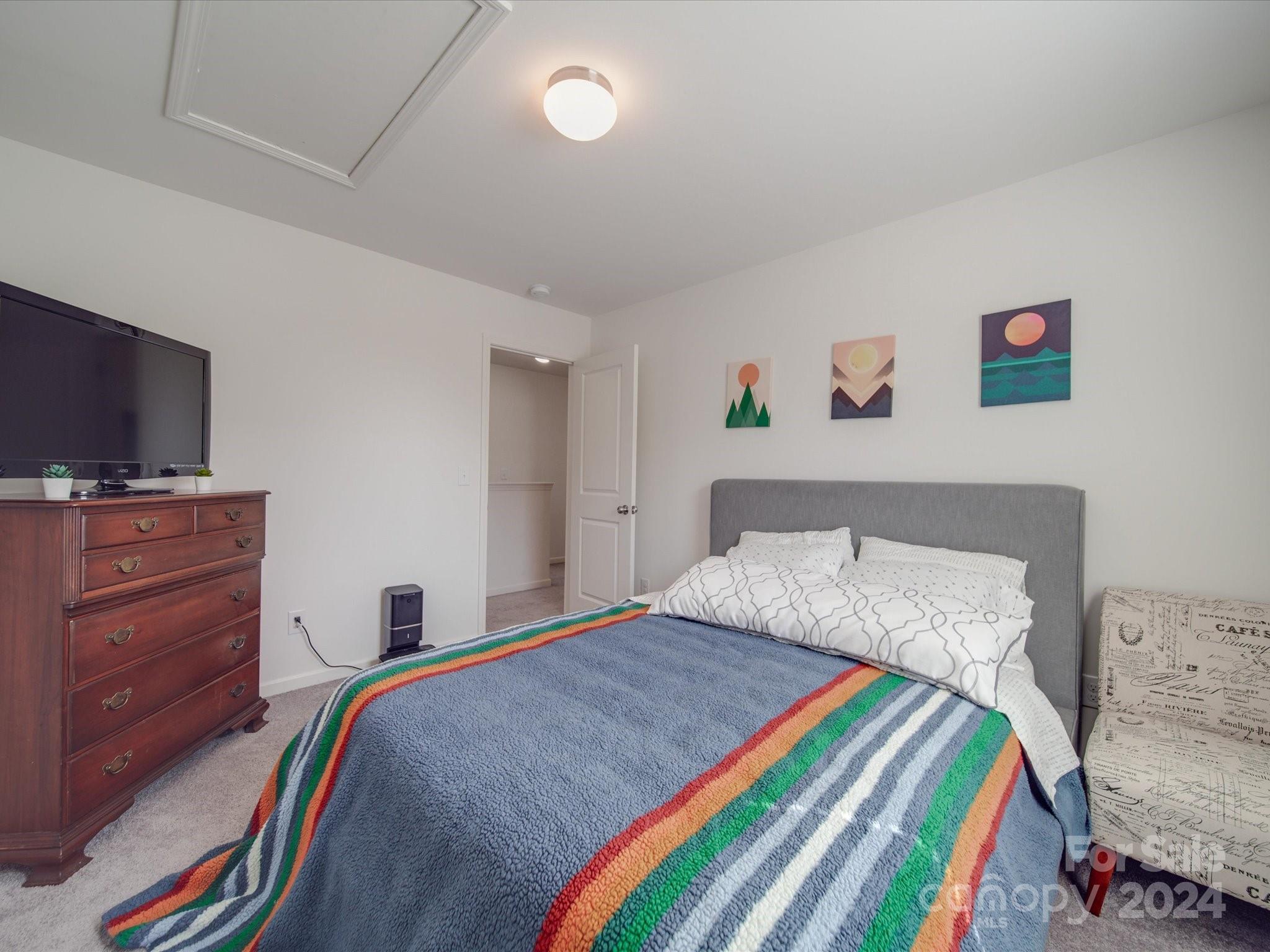 3824 Tersk Drive Midland, NC 28107 - Photo 25 of 39 a bedroom with a bed and a flat screen tv