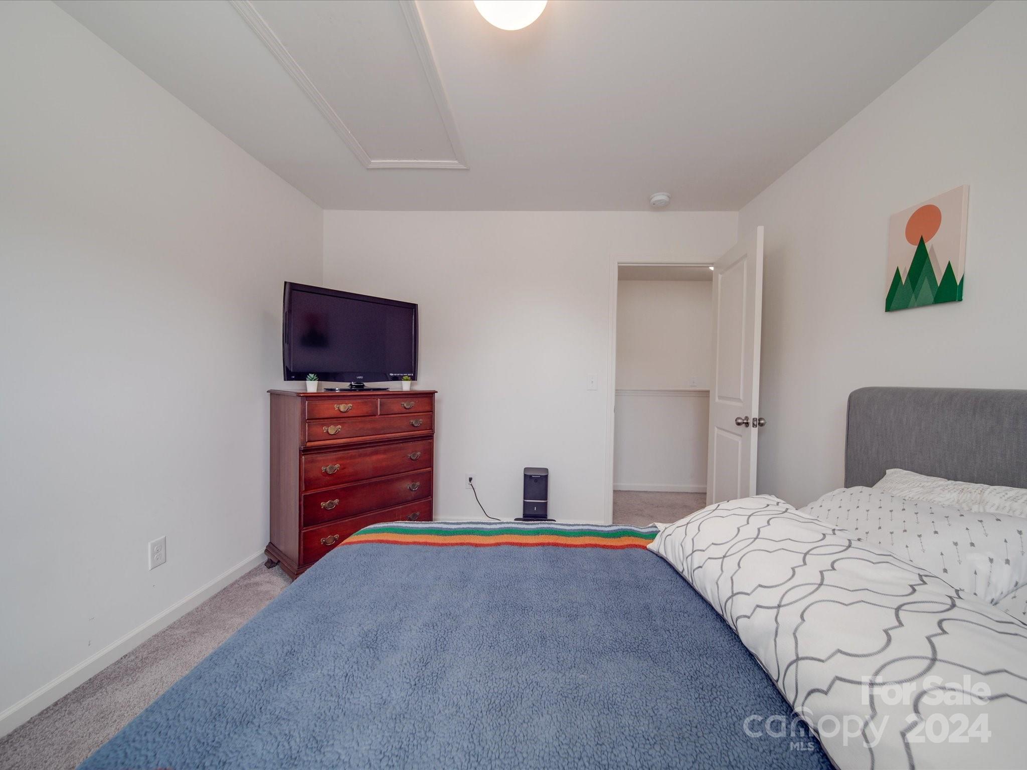 3824 Tersk Drive Midland, NC 28107 - Photo 26 of 39 a bedroom with a bed and a flat screen tv