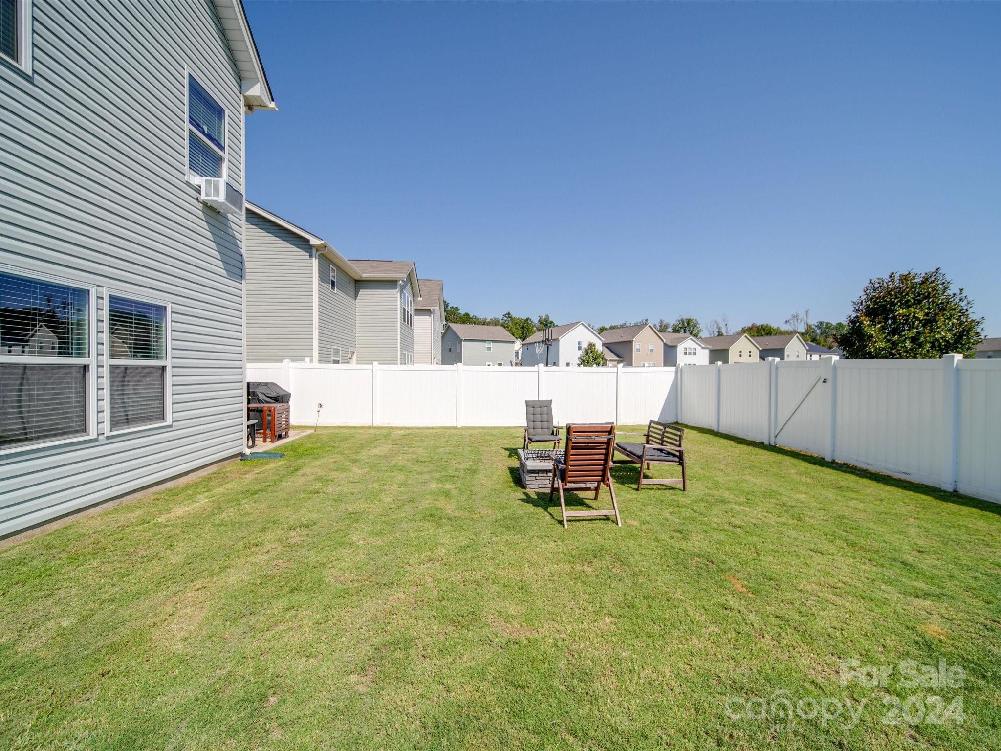 3824 Tersk Drive Midland, NC 28107 - Photo 33 of 39 a backyard of a house with table and chairs