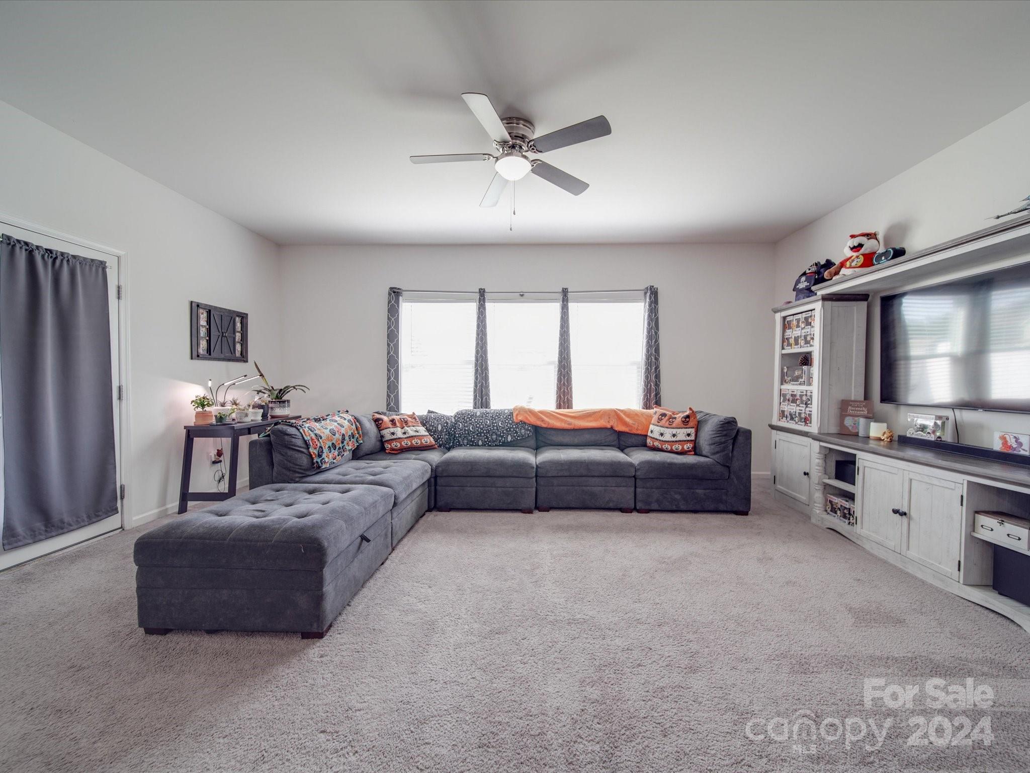 3824 Tersk Drive Midland, NC 28107 - Photo 7 of 39 a living room with furniture and a flat screen tv