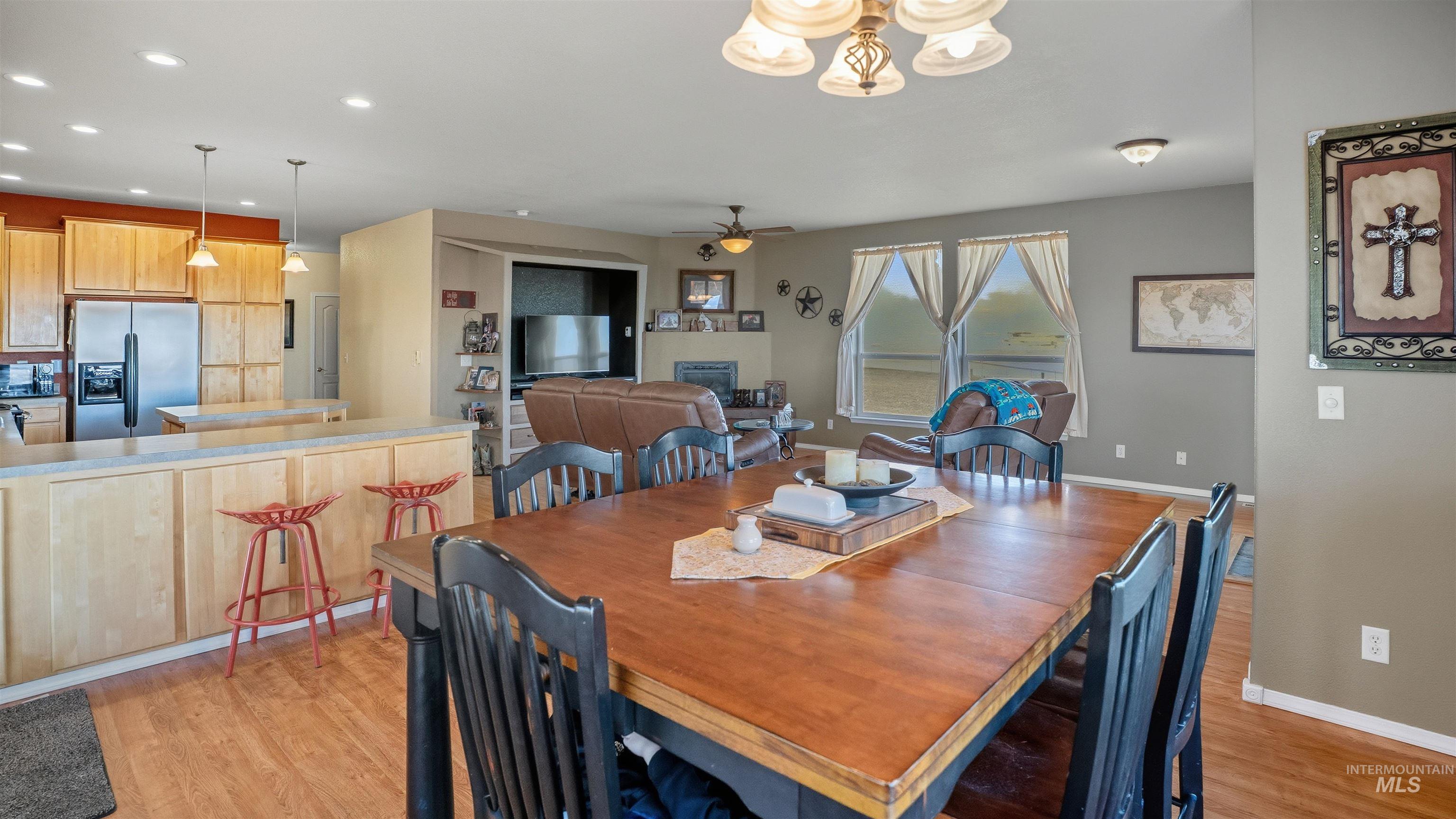 19397 Cloverland Road Asotin, WA 99402 - Photo 12 of 35 Dining area with light wood-style floors, suspended lighting, and a ceiling fan