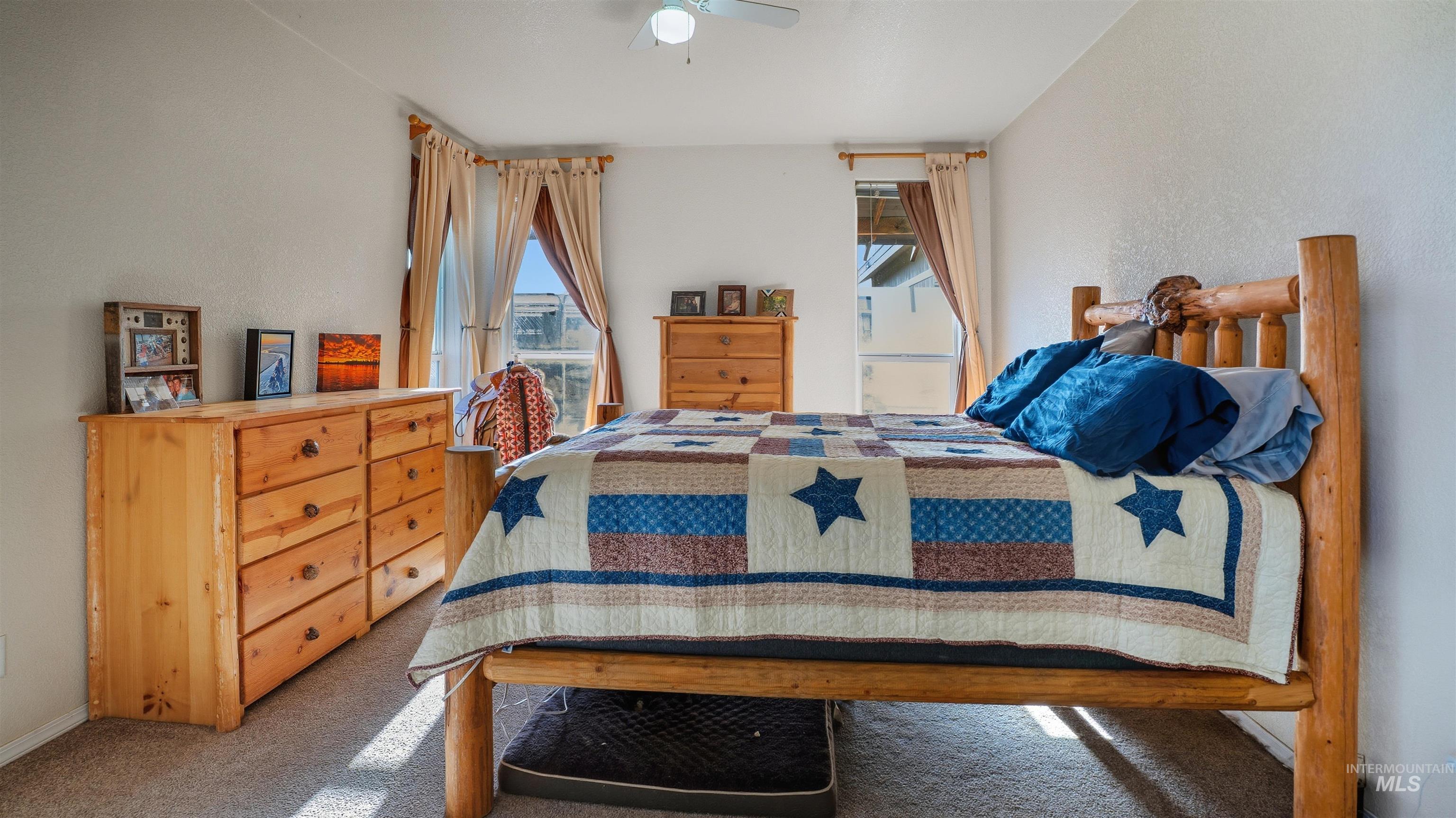 19397 Cloverland Road Asotin, WA 99402 - Photo 15 of 35 Carpeted bedroom featuring a ceiling fan and a textured wall