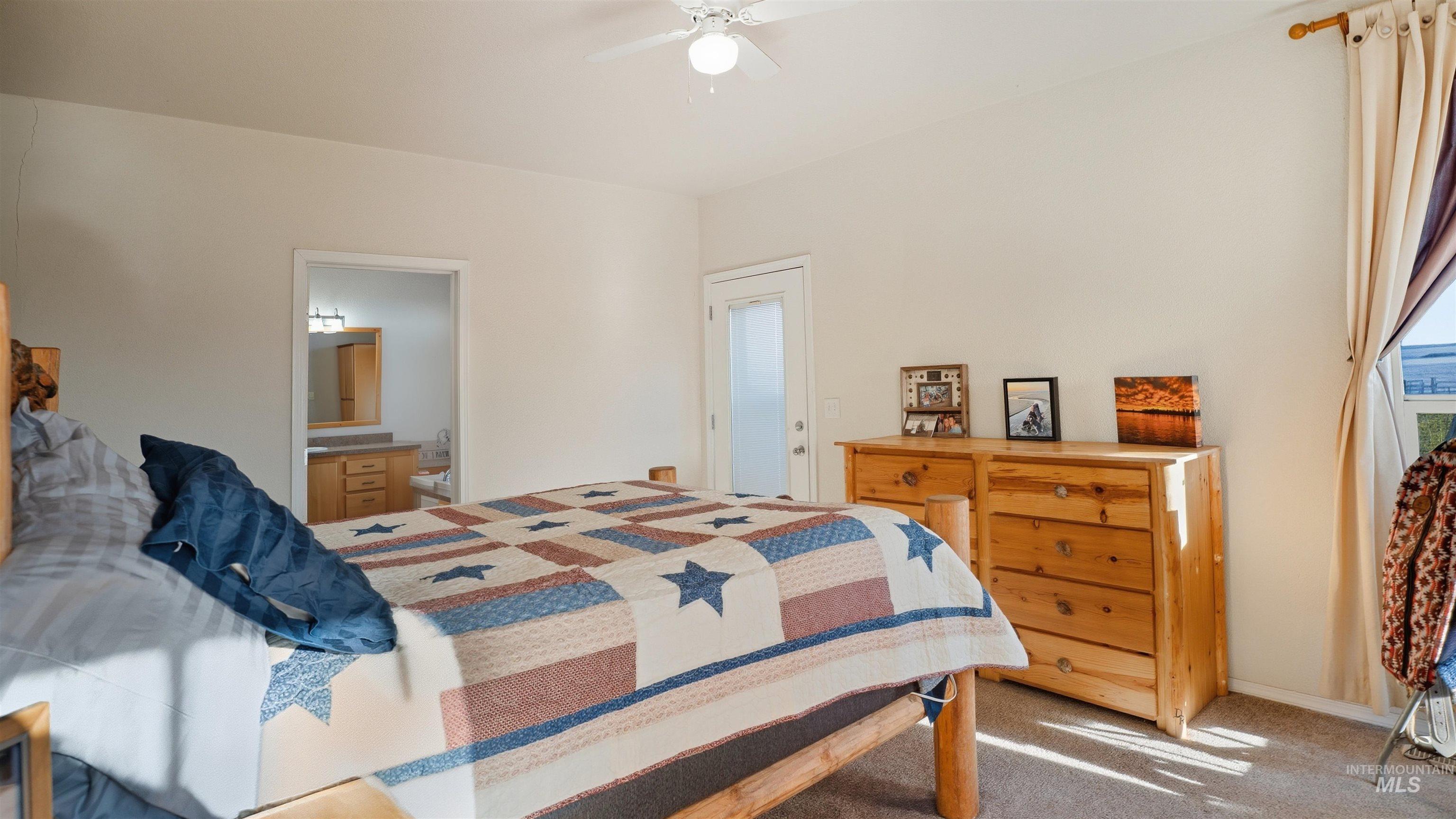19397 Cloverland Road Asotin, WA 99402 - Photo 16 of 35 Bedroom with carpet floors, a ceiling fan, and connected bathroom