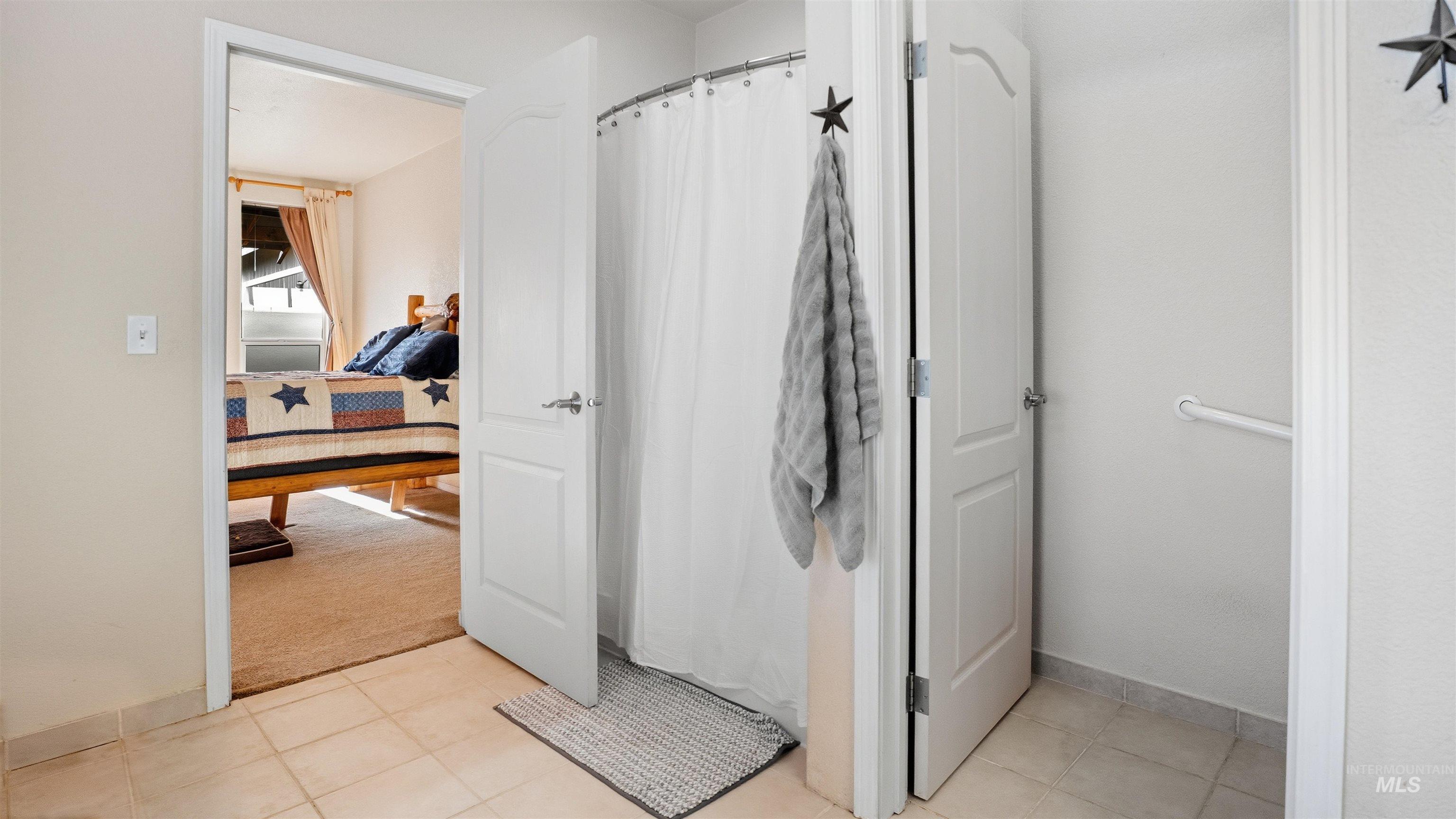 19397 Cloverland Road Asotin, WA 99402 - Photo 19 of 35 Full bath with curtained shower, light tile patterned floors, and light carpet