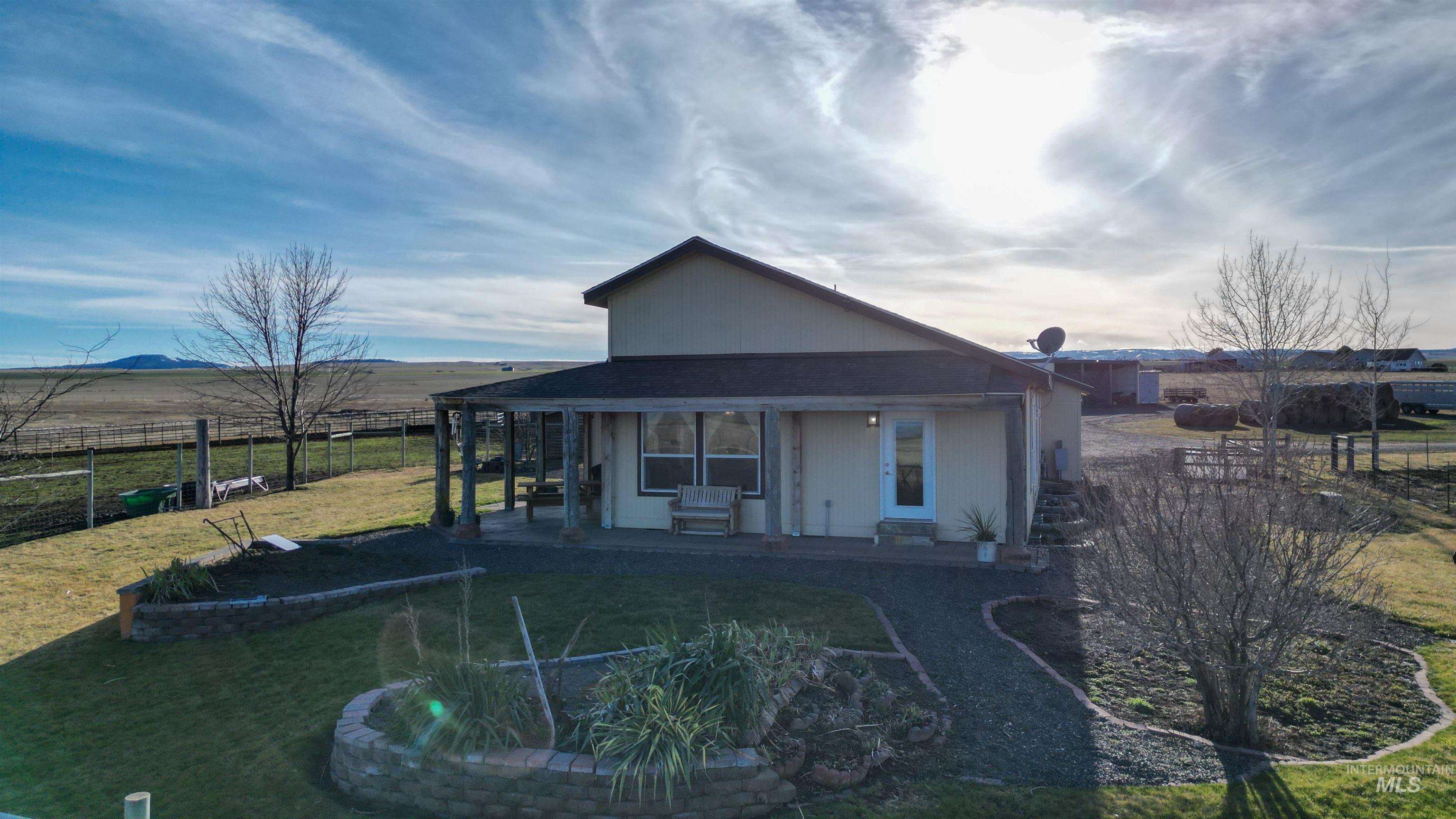 19397 Cloverland Road Asotin, WA 99402 - Photo 31 of 35 Rear view of house featuring a view of countryside, a patio area, and a shingled roof