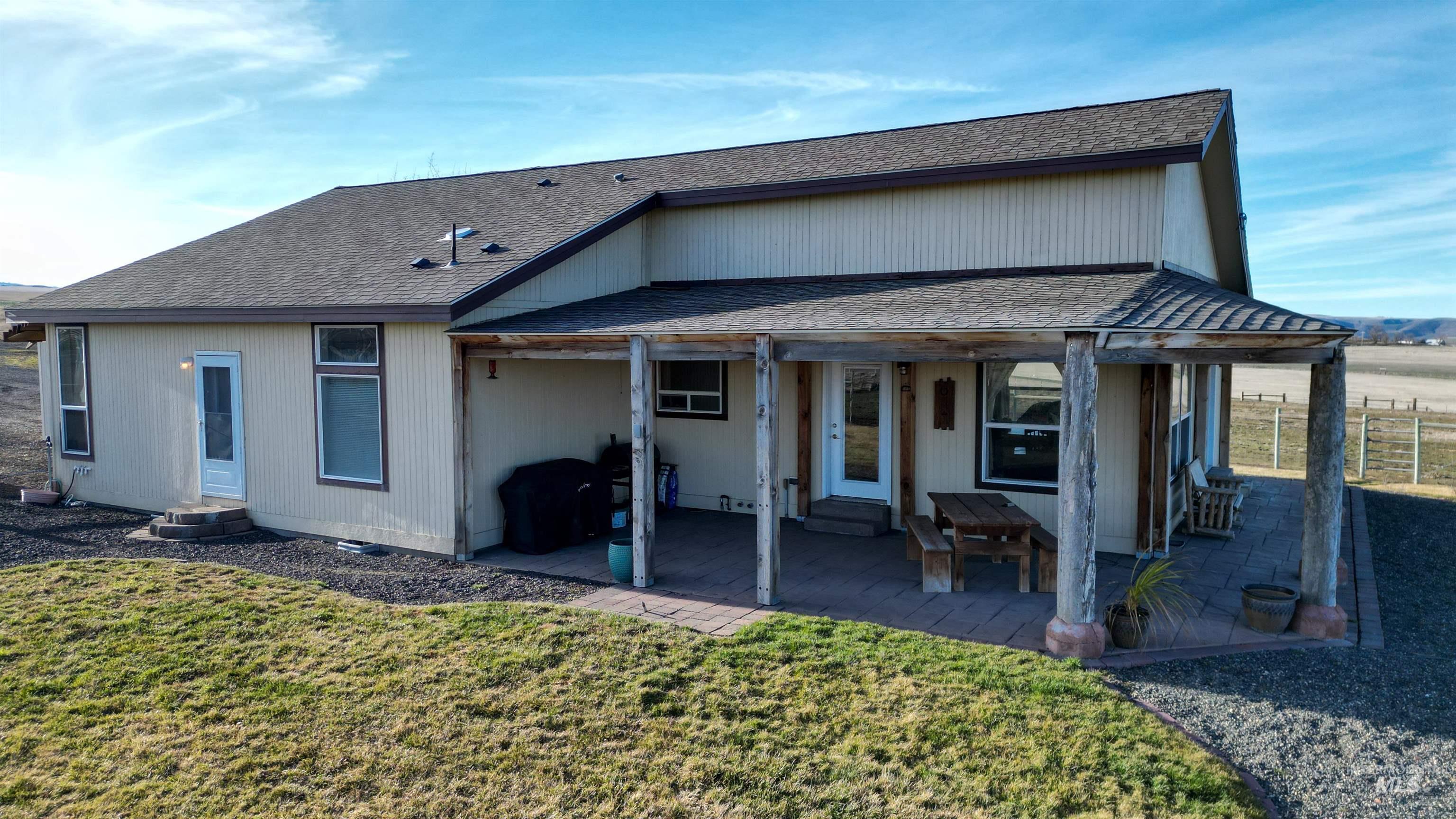19397 Cloverland Road Asotin, WA 99402 - Photo 7 of 35 Back of property featuring roof with shingles and a patio