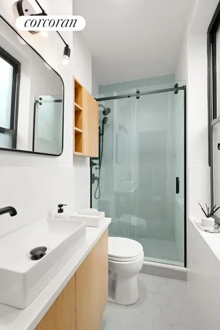 a bedroom with a bed and painting on the wall