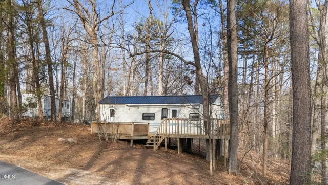 a view of a house with a yard and roof deck