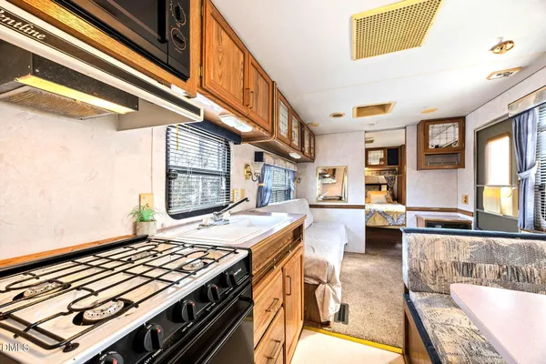a view of a living room and kitchen stove
