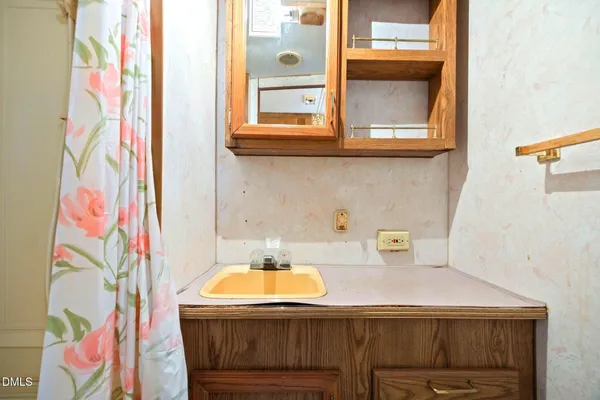 a bathroom with a sink and a mirror