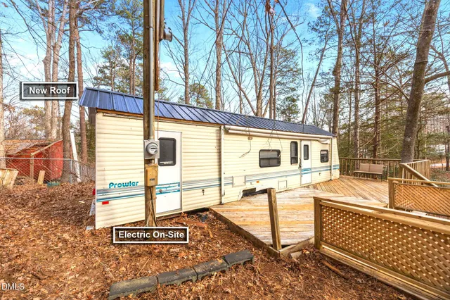 a view of a swimming pool with a bench and lawn chairs