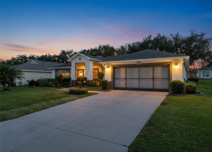 a front view of a house with a yard and a garage