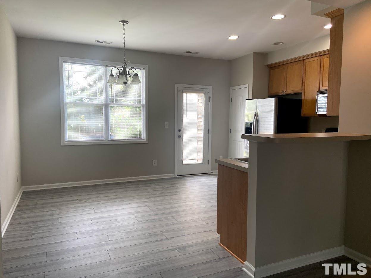 5105 Powell Townes Way Raleigh, NC 27606 - Photo 4 of 14 an empty room with wooden floor and windows