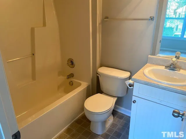 a white toilet sitting next to a bath tub