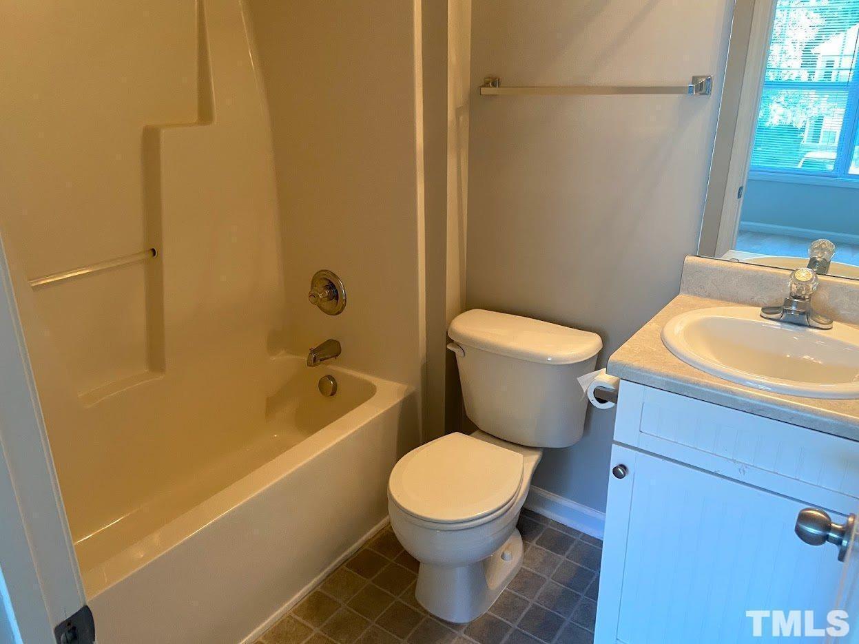 5105 Powell Townes Way Raleigh, NC 27606 - Photo 10 of 14 a white toilet sitting next to a bath tub