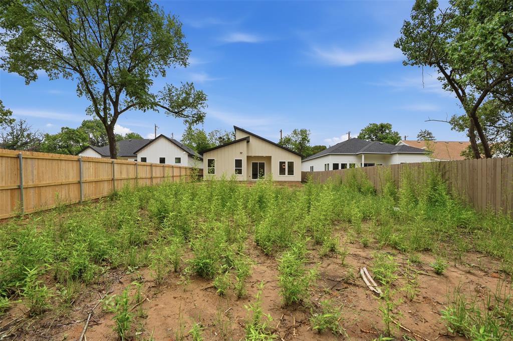 1111 Riverwood Road Dallas, TX 75217 - Photo 10 of 40 Spacious backyard featuring a new wood fence and mature trees