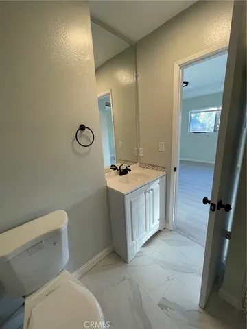 a bathroom with a sink a toilet and mirror