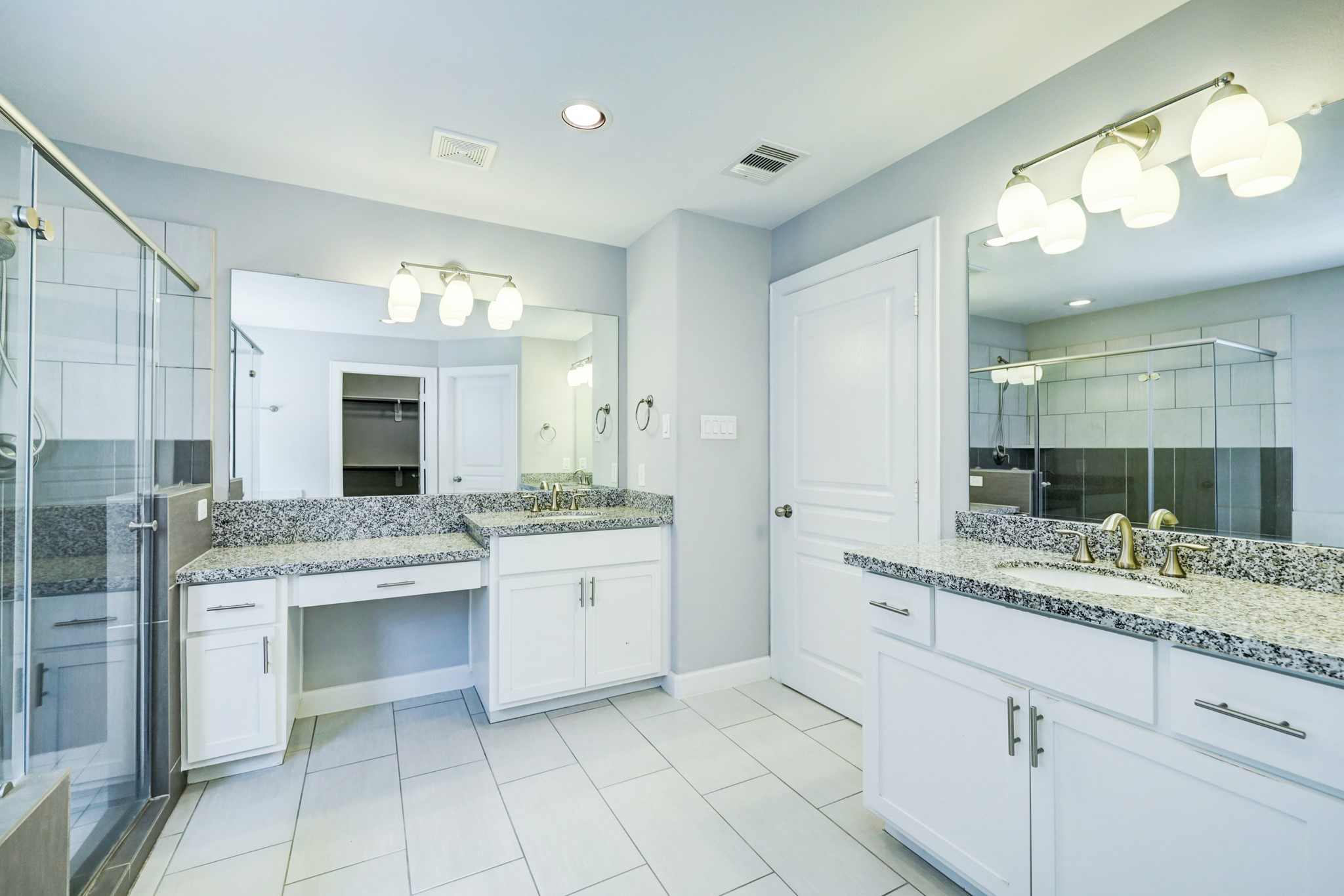 1811 Wichita Street, Unit A Houston, TX 77004 - Photo 19 of 29 a bathroom with a granite countertop sink a toilet a mirror and vanity