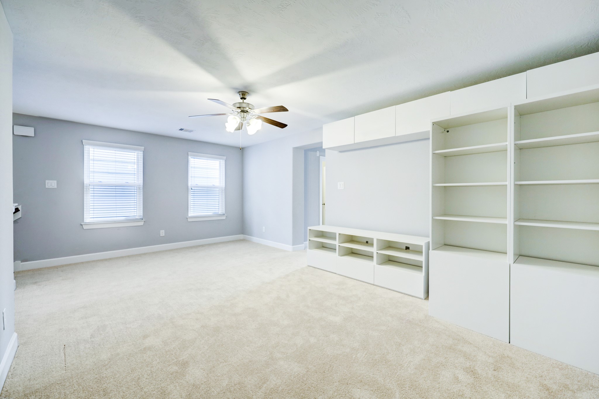 1811 Wichita Street, Unit A Houston, TX 77004 - Photo 24 of 29 an empty room with windows and ceiling fan
