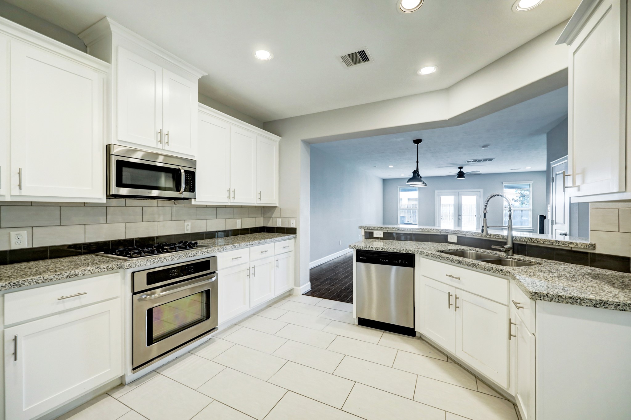 1811 Wichita Street, Unit A Houston, TX 77004 - Photo 7 of 29 a kitchen with granite countertop white cabinets and stainless steel appliances