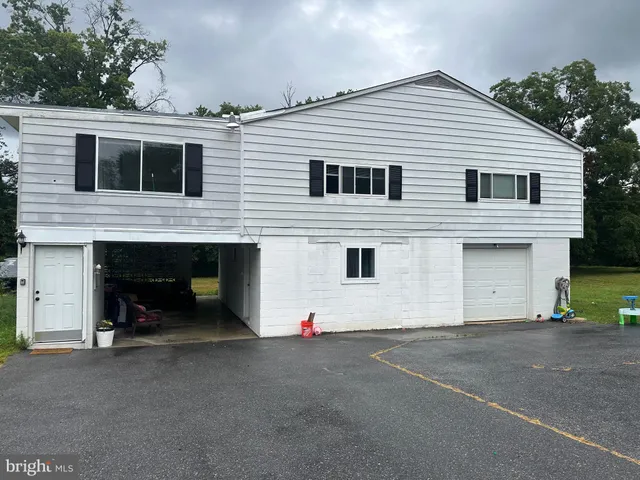 a view of a white house with a yard