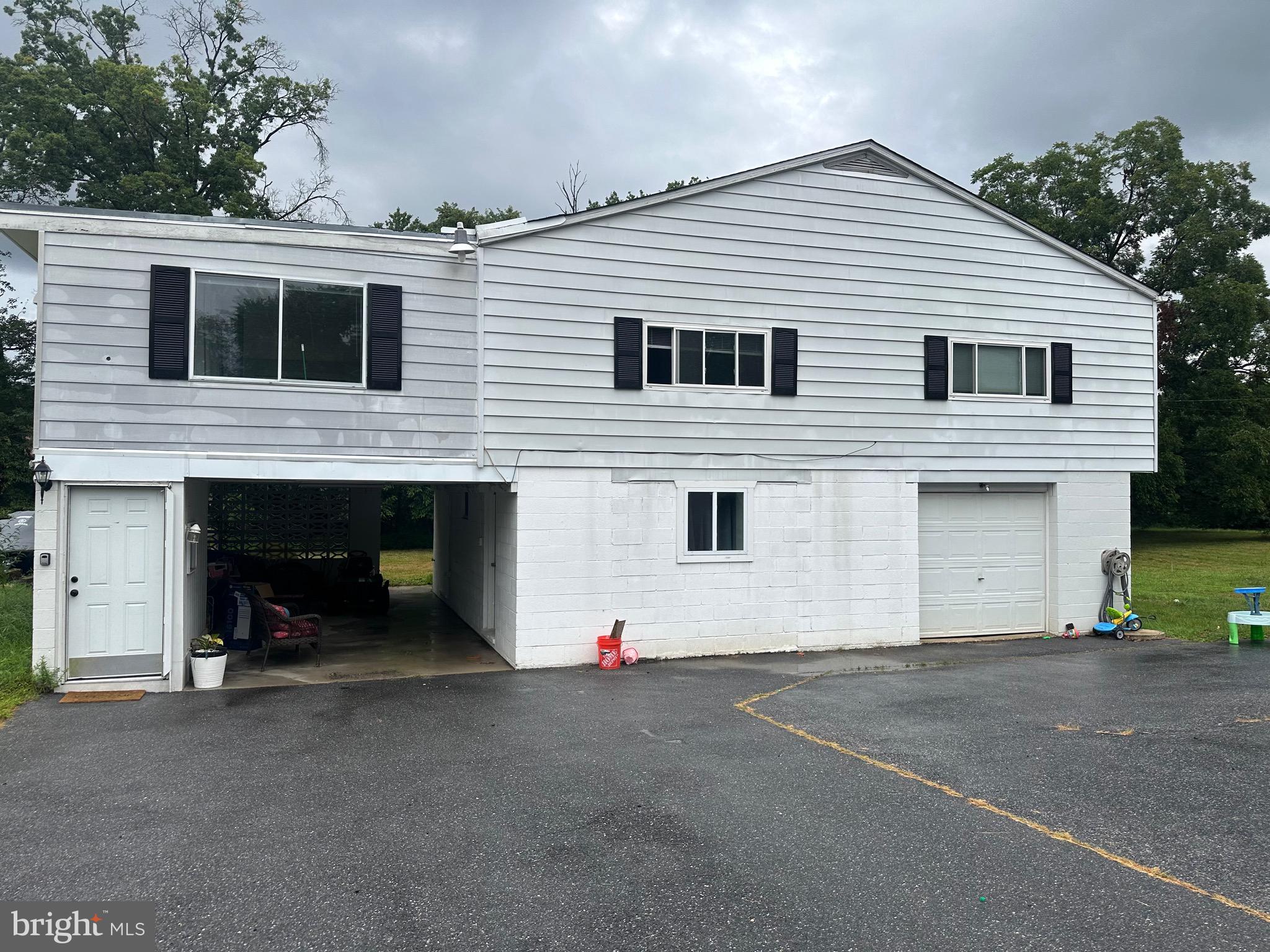 a view of a white house with a yard