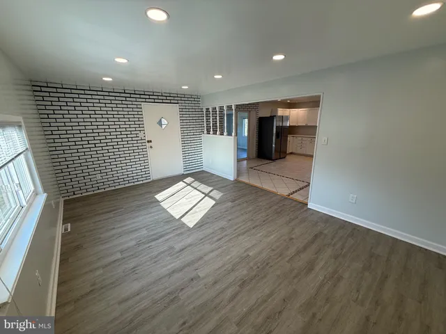 a large kitchen with a large counter top space appliances and cabinets