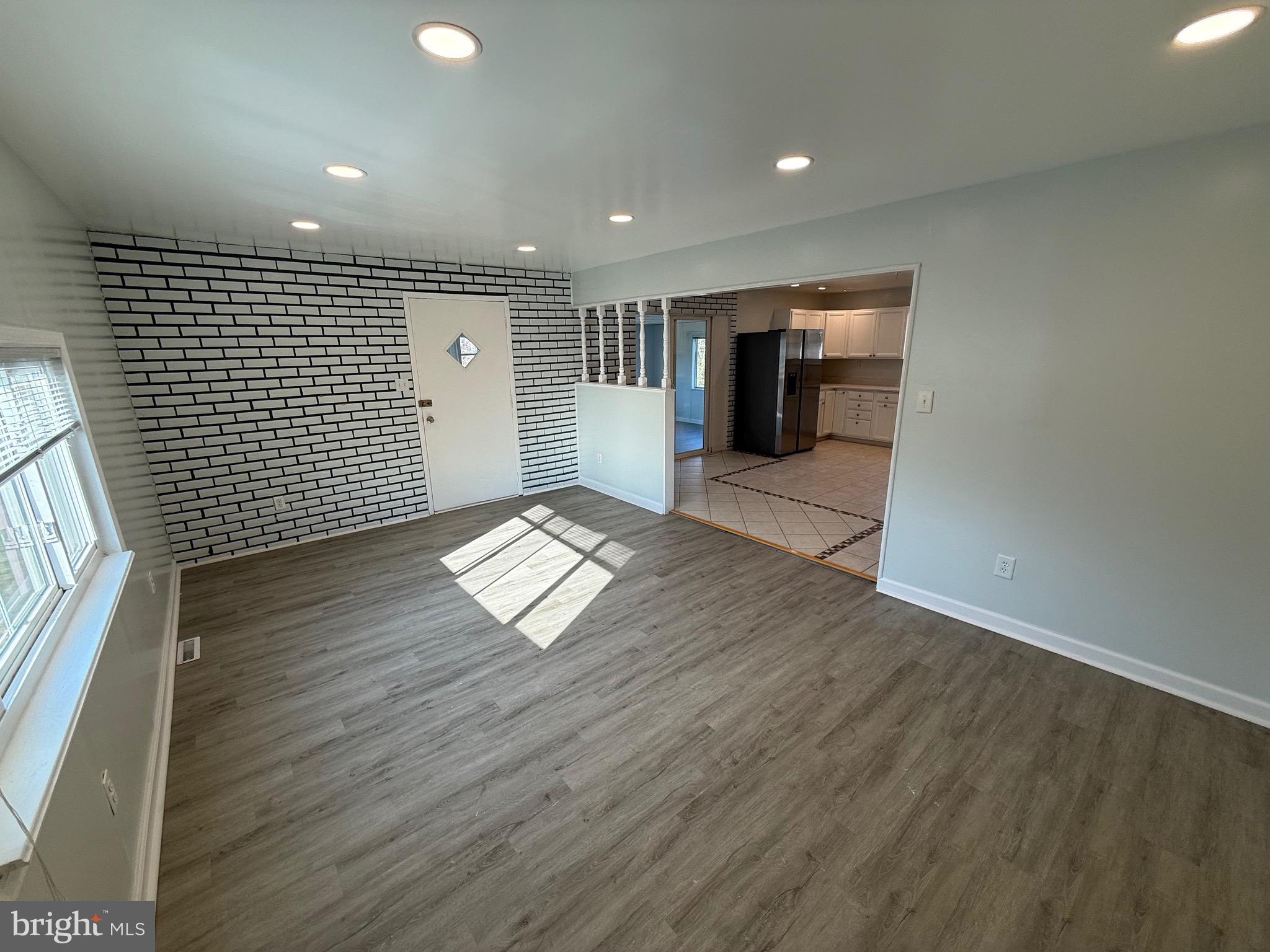 1214 Reece Road Severn, MD 21144 - Photo 12 of 25 an empty room with wooden floor and windows
