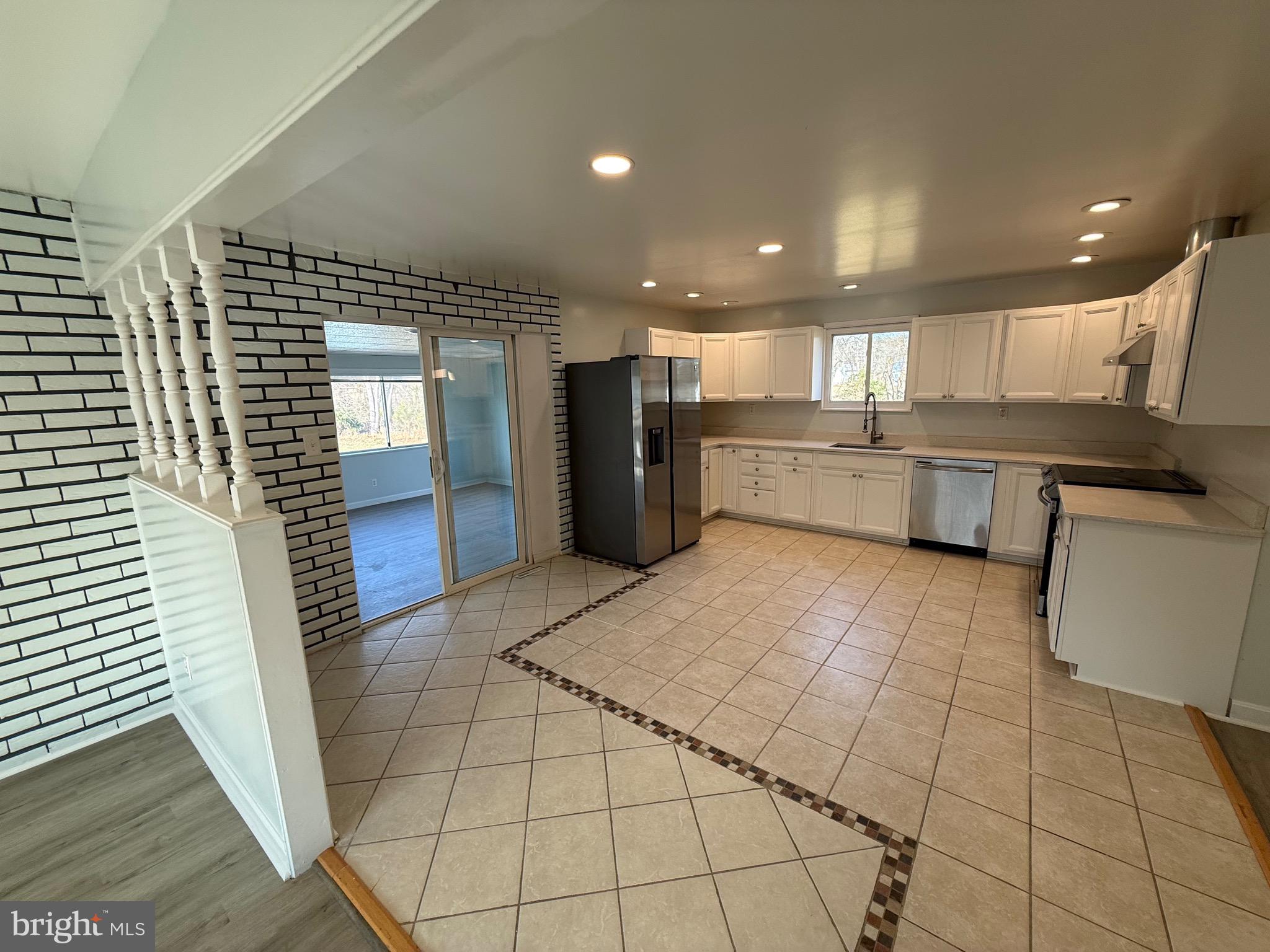 1214 Reece Road Severn, MD 21144 - Photo 13 of 25 a large kitchen with a large counter top space appliances and cabinets