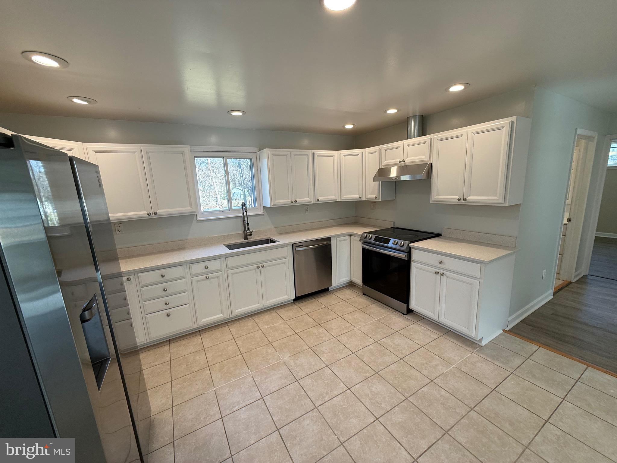1214 Reece Road Severn, MD 21144 - Photo 15 of 25 a kitchen with a sink a refrigerator and cabinets