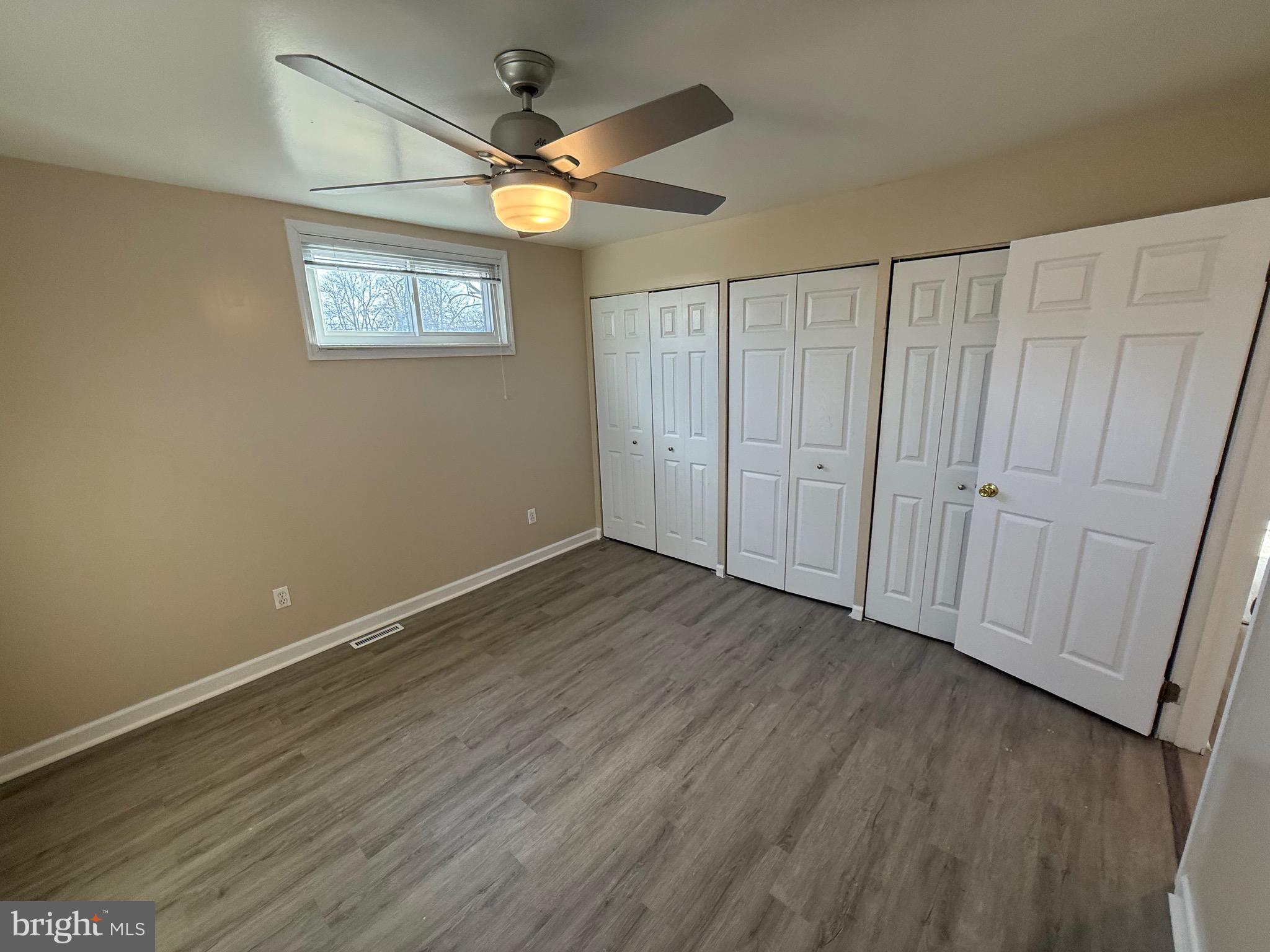 1214 Reece Road Severn, MD 21144 - Photo 20 of 25 an empty room with wooden floor fan and windows