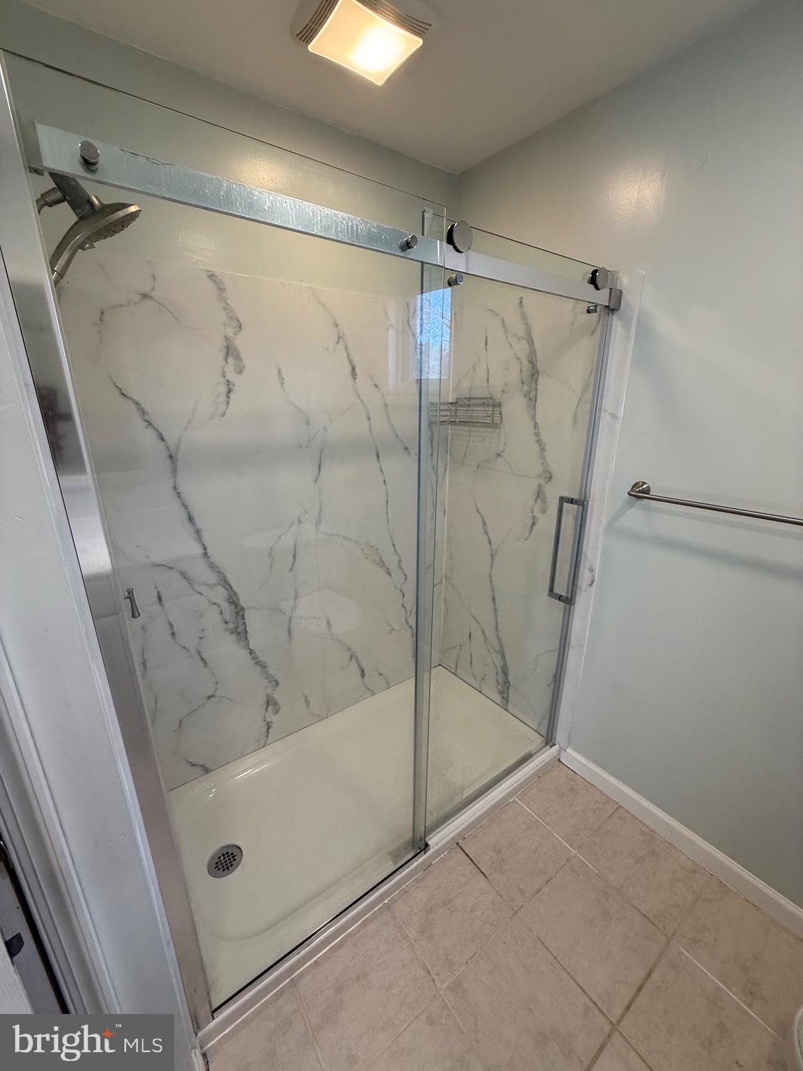 1214 Reece Road Severn, MD 21144 - Photo 23 of 25 a bathroom with a bathtub and a shower