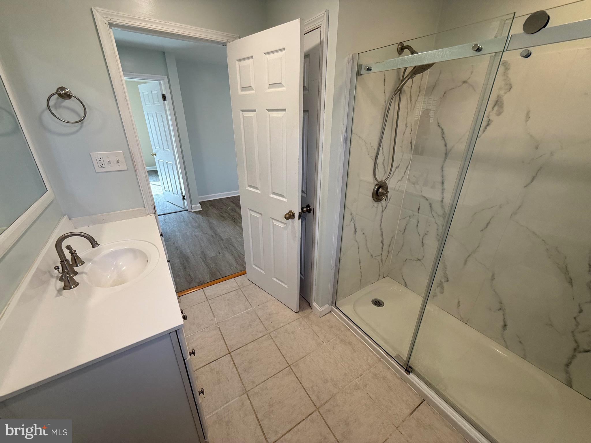 1214 Reece Road Severn, MD 21144 - Photo 25 of 25 a bathroom with a granite countertop sink a mirror and shower