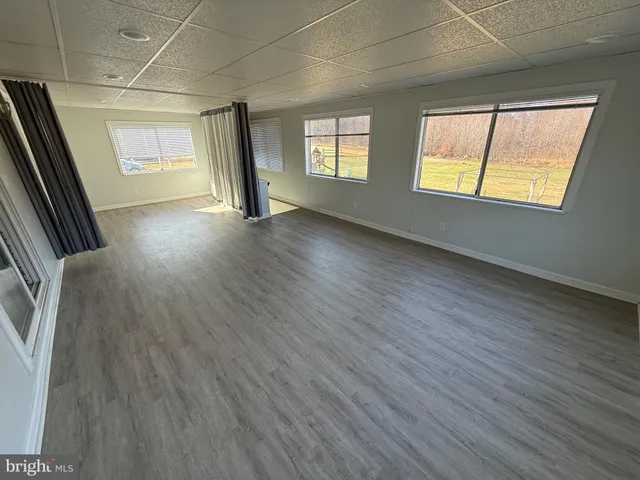 an entryway with wooden floor and windows