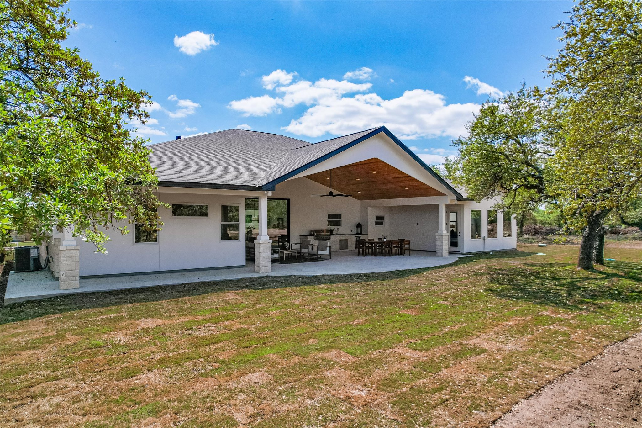 410 Shady Tree Drive Georgetown, TX 78633 - Photo 29 of 40 Back of property with a lawn, a patio, a shingled roof, and stucco siding