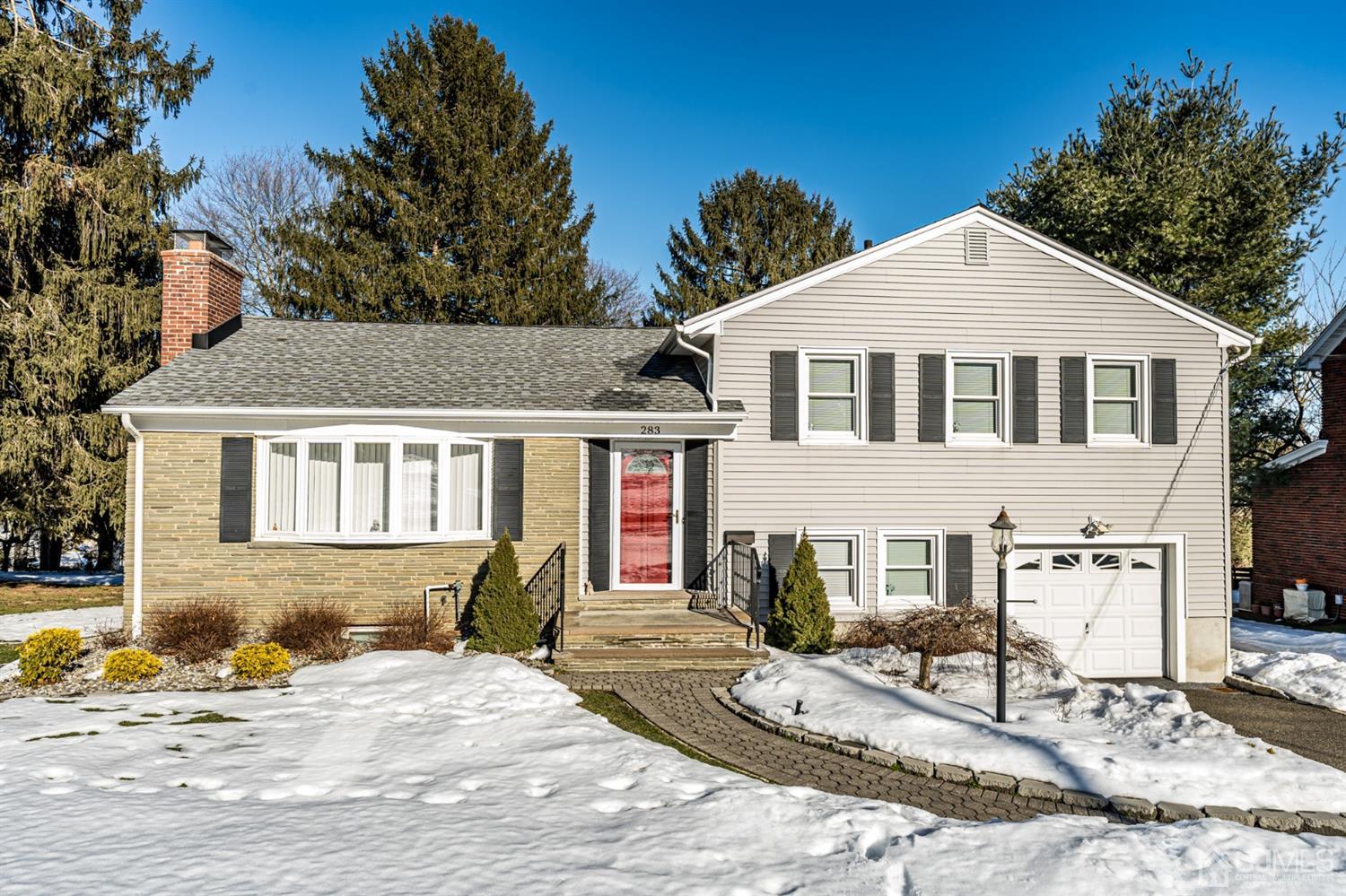 283 Baltusrol Way Springfield, NJ 07081 - Photo 1 of 20 a front view of a house with a yard