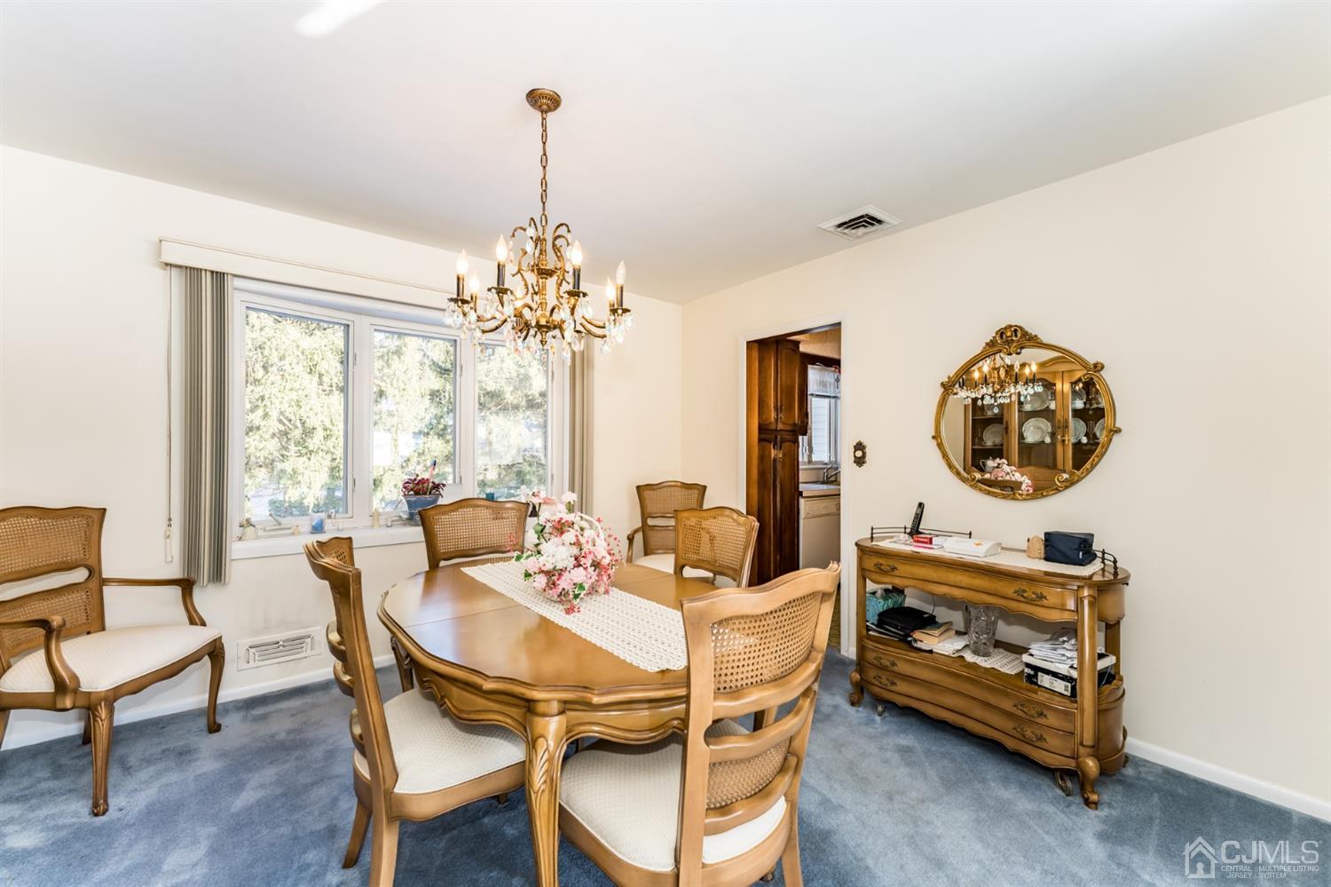 283 Baltusrol Way Springfield, NJ 07081 - Photo 7 of 20 a dining room with furniture a chandelier and a rug