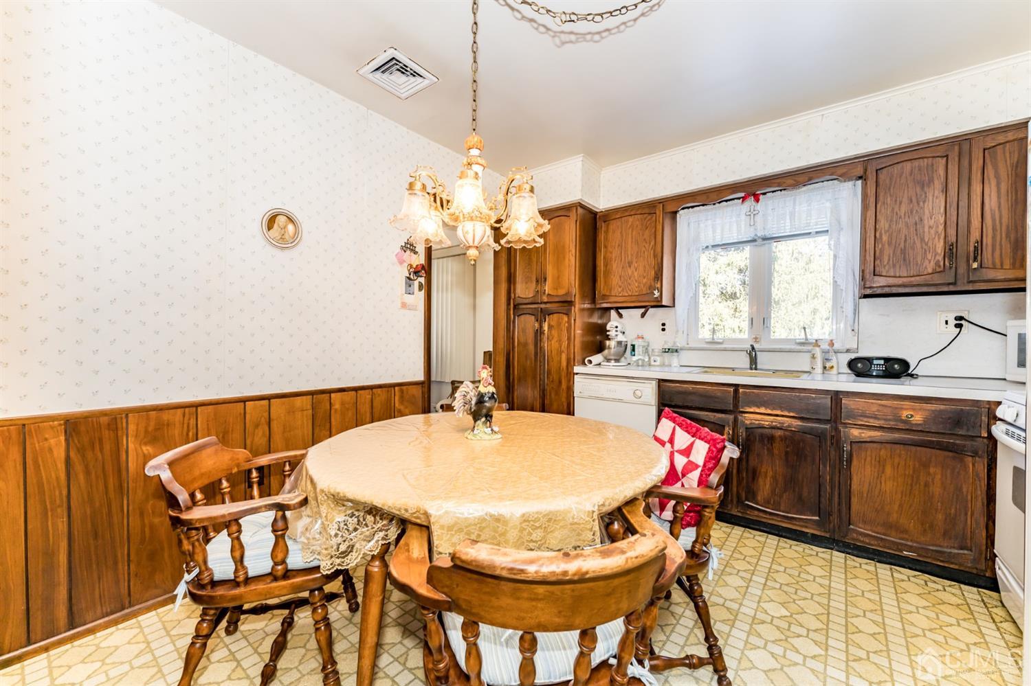 283 Baltusrol Way Springfield, NJ 07081 - Photo 9 of 20 a dining room with a table chairs a sink and dishwasher