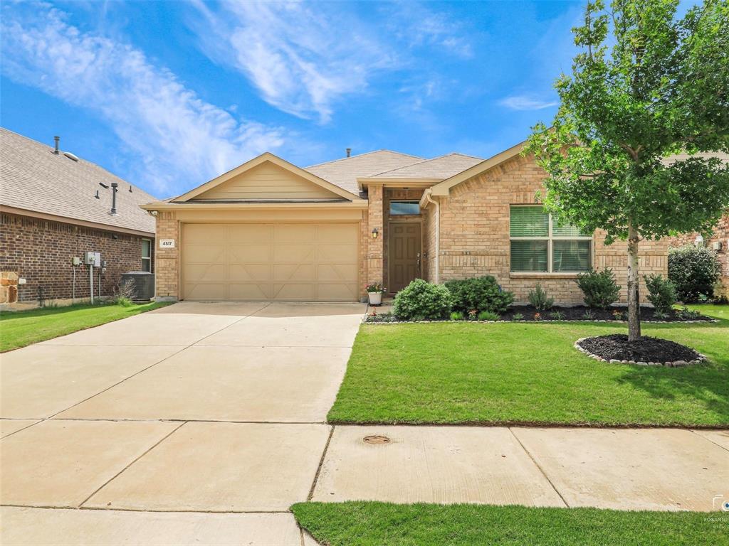 4517 Ashmark Road Aubrey, TX 76227 - Photo 1 of 26 a front view of a house with a yard and garage