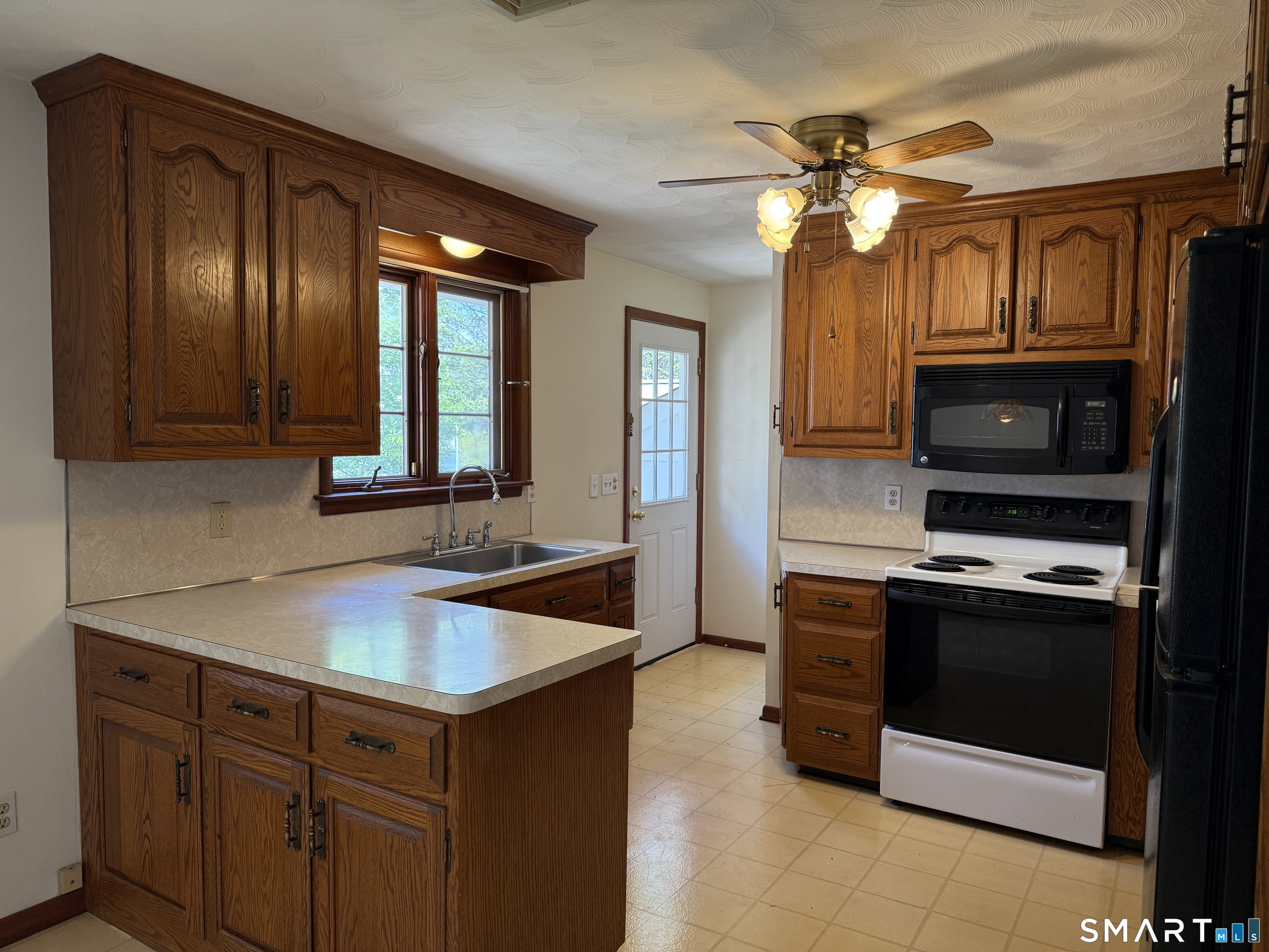 26 Maple Street Trumbull, CT 06611 - Photo 13 of 37 a kitchen with a sink and a stove top oven