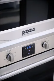 a spacious bedroom with a bed and a chandelier