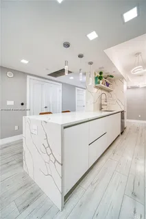 a kitchen with a refrigerator and cabinets